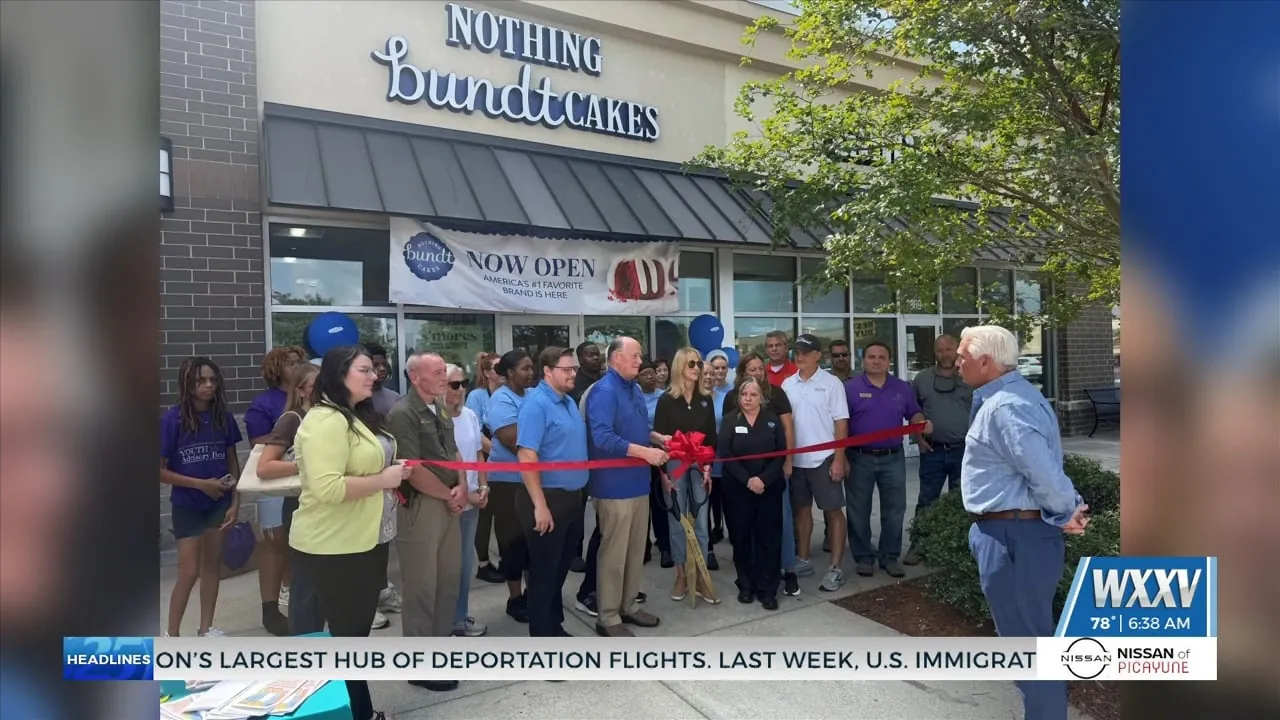 City officials and community members at a Nothing Bundt Cakes ribbon cutting outside a bakery storefront