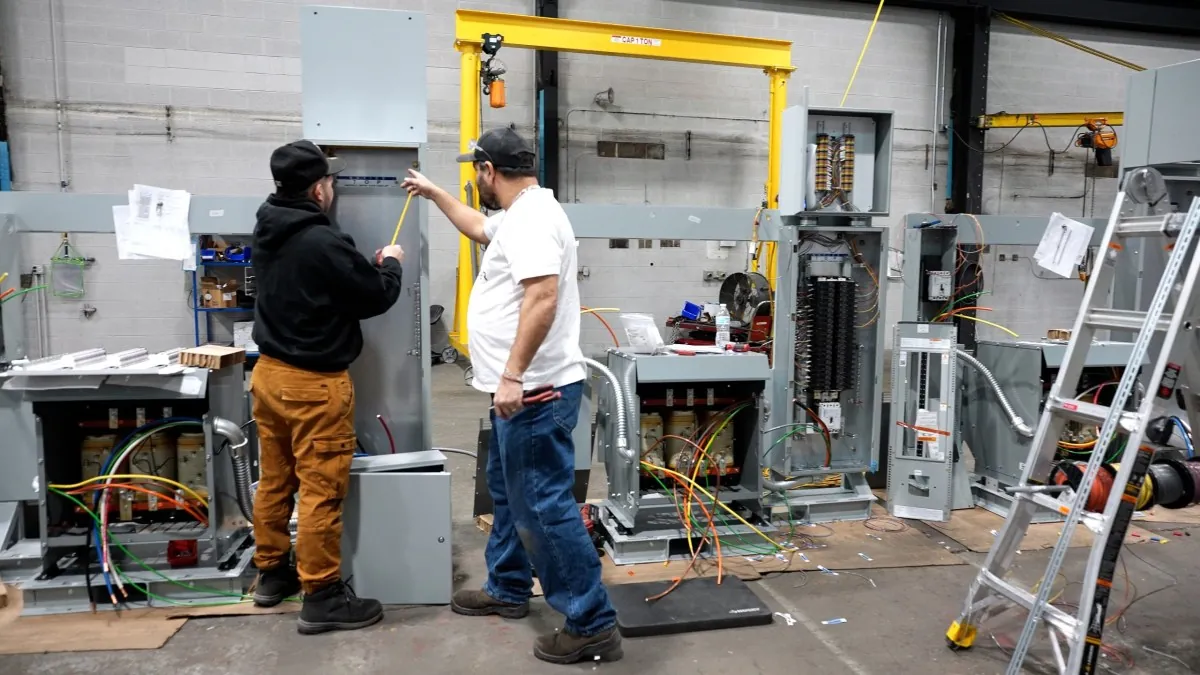 Skilled construction trades workers in hard hats and safety vests on a data center build site