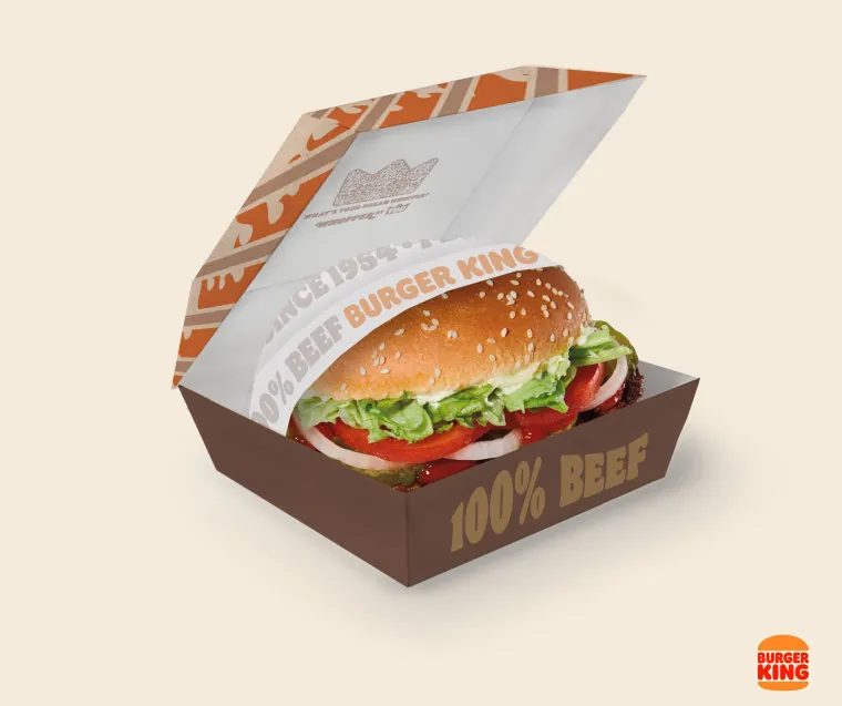 A freshly prepared Burger King Whopper showing the upgraded bun, flame-grilled patty, vegetables, and condiments