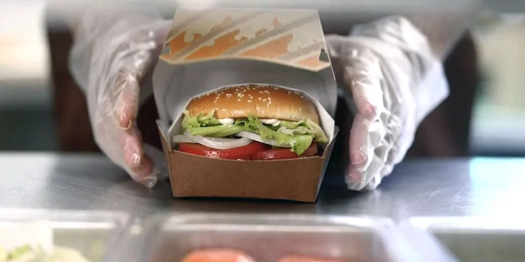 A Burger King Whopper sandwich presented in an elevated product shot