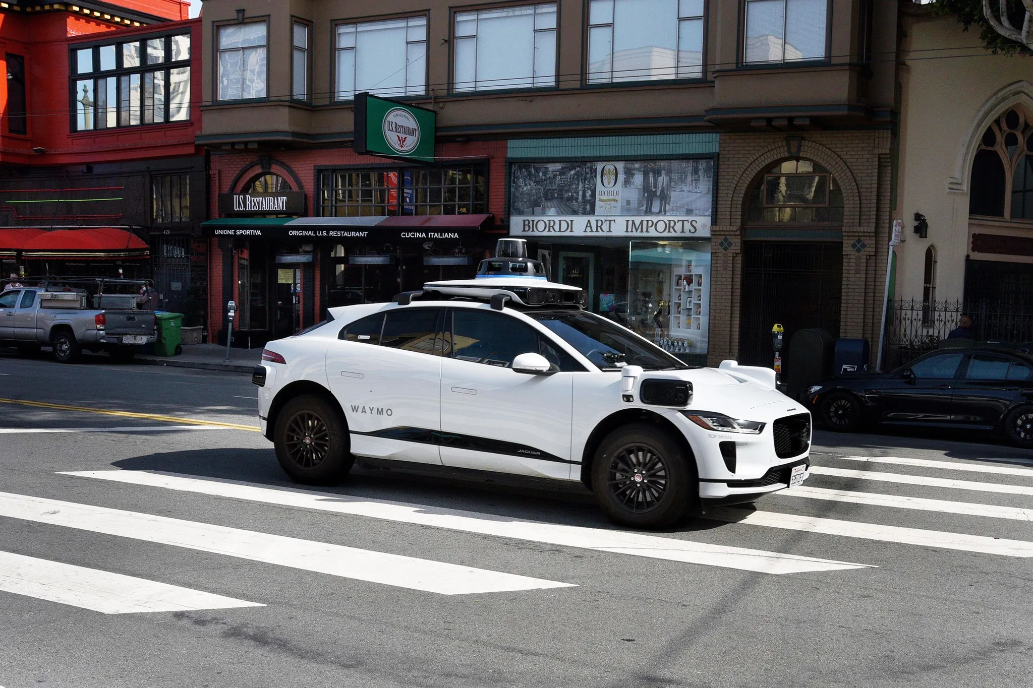Waymo robotaxi driving on a San Francisco street among other traffic